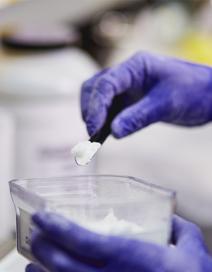 Sensient-website-420x540_0000s_0039-scientist-handing-materials-13-powder